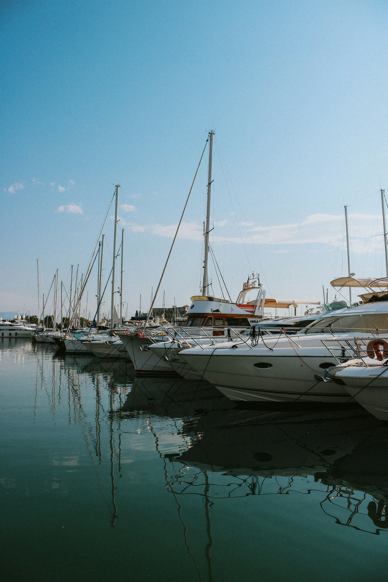 Motor yacht alongside a dock, illustrating yacht acquisition context.